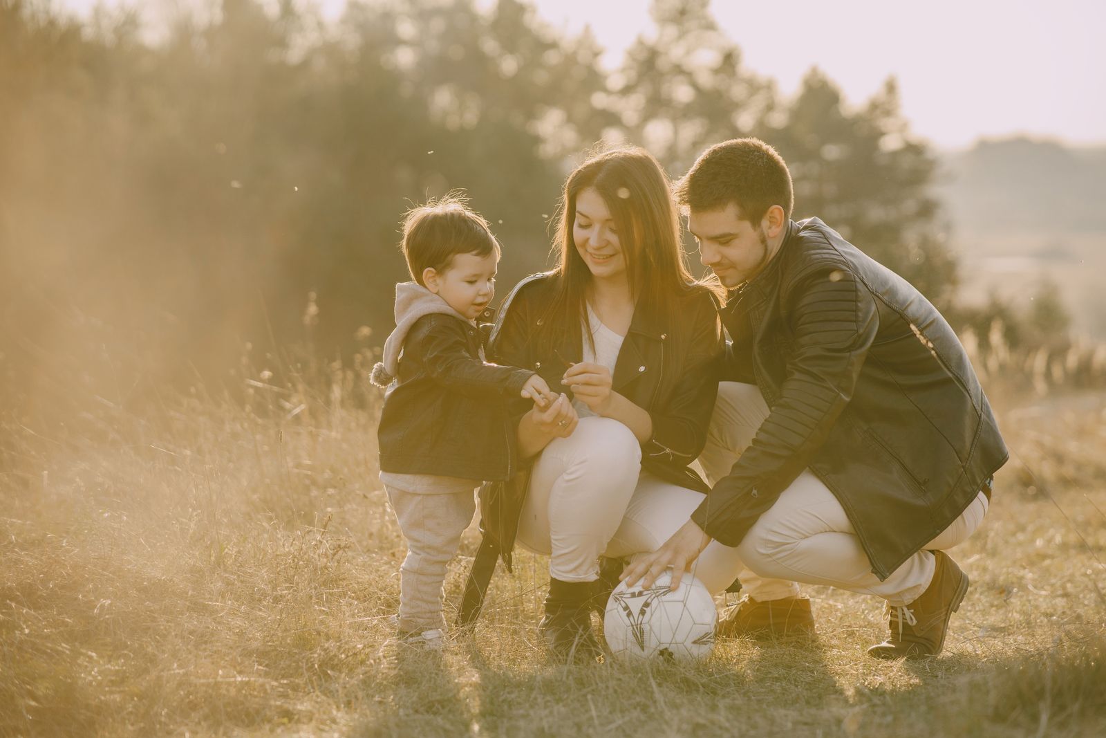 A family walking together through a field at golden hour