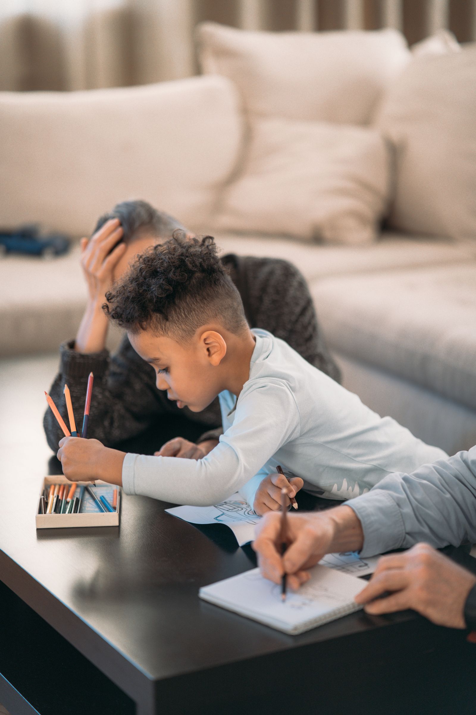 Two children drawing quietly at a low table
