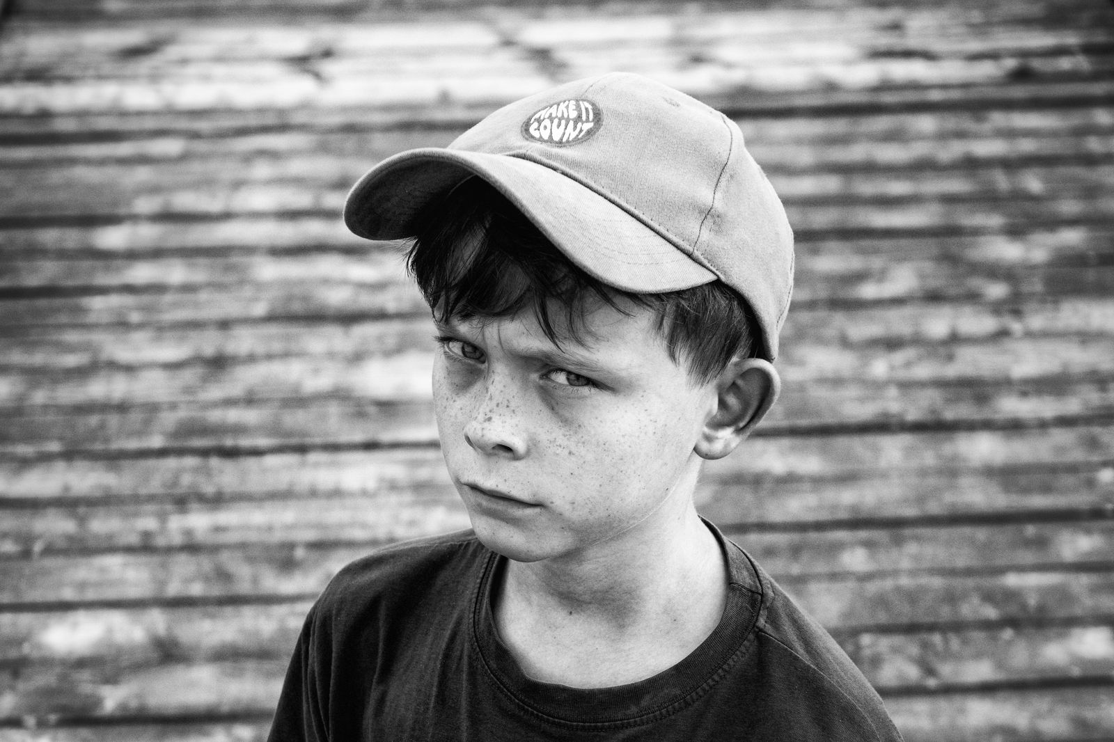 A thoughtful boy in a cap, photographed in black and white